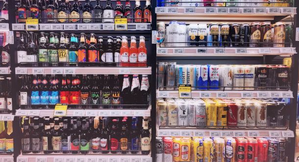 assorted bottles and cans in commercial coolers